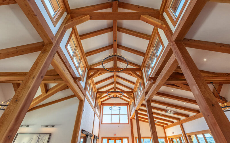 Inside a Rustic timber hall with tall exposed redwood beams